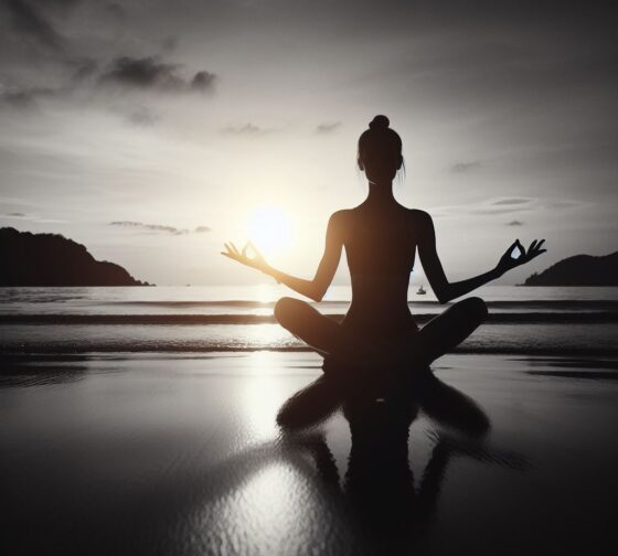 person meditating with a  sunset